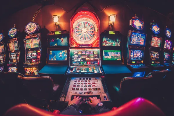 A close-up shot of golden coins falling around a spinning roulette wheel, representing immersive casino action at K677.