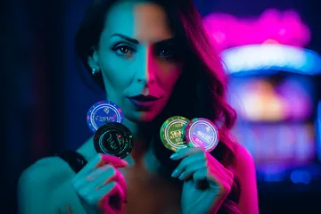 A woman smiling by bright slot machines showing lucky symbols, showcasing the exciting slot offerings at K677.